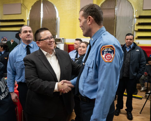 FDNY Commissioner Lillian Bonsignore greets an EMS Lieutenant before th ceremony commemorating the 30th anniversary of the merger of NYC Health and Hospitals EMS with FDNY at the FDNY EMS Bureau of Training in Ft. Totten Park on Monday, March 16, 2026 in Queens, New York. (Barry Williams/ New York Daily News)