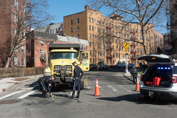 The NYPD Highway Patrol investigates after a pedestrian was fatally struck by a DOT truck on Lefferts Blvd. and 84th St. in Queens, New York City on Tuesday, March 10, 2026. (Gardiner Anderson / New York Daily News)