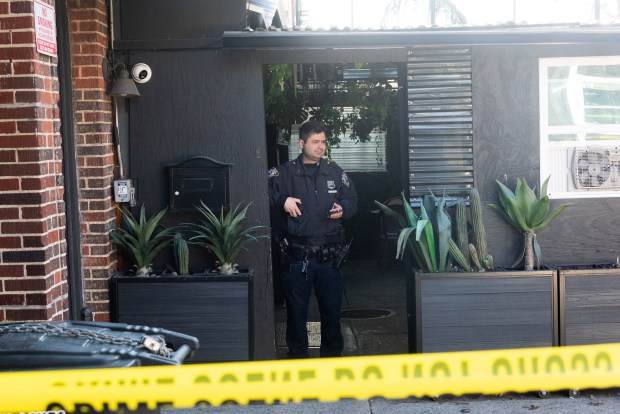 Police investigate a fatal shooting at 119-11 Metropolitan Ave. in Kew Gardens, Queens, on Tuesday, March 24, 2026. (Gardiner Anderson / New York Daily News)