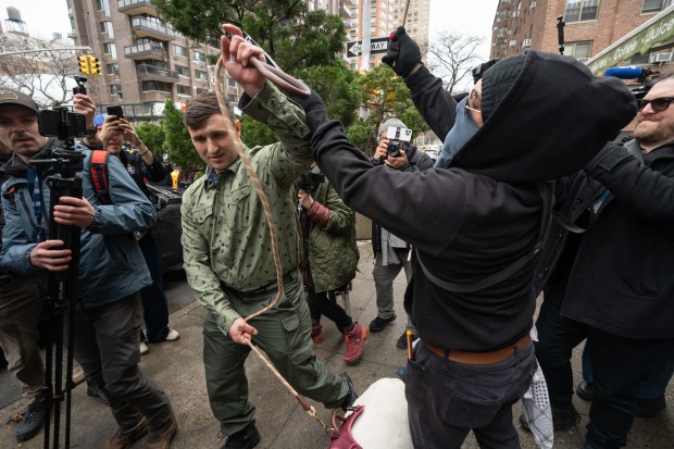 Jake Lang walks with a goat to a secured protest area near Gracie Mansion with NYPD protection Saturday, March 7, 2026, in Manhattan, New York. (Barry Williams/ New York Daily News)