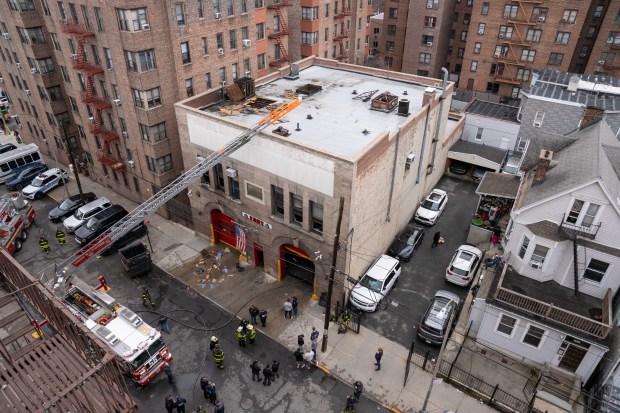 Firefighters work the scene after a two-alarm fire inside an FDNY firehouse, home to Battalion 27, Engine 79 and Ladder 37, in the Bronx on Friday, March 27, 2026. (Theodore Parisienne / New York Daily News)