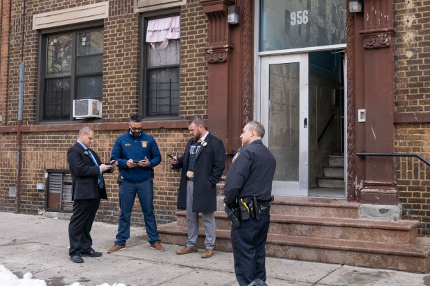 Police investigate at the apartment building on Sherman Ave. near E. 163rd St. in the Bronx on Saturday.