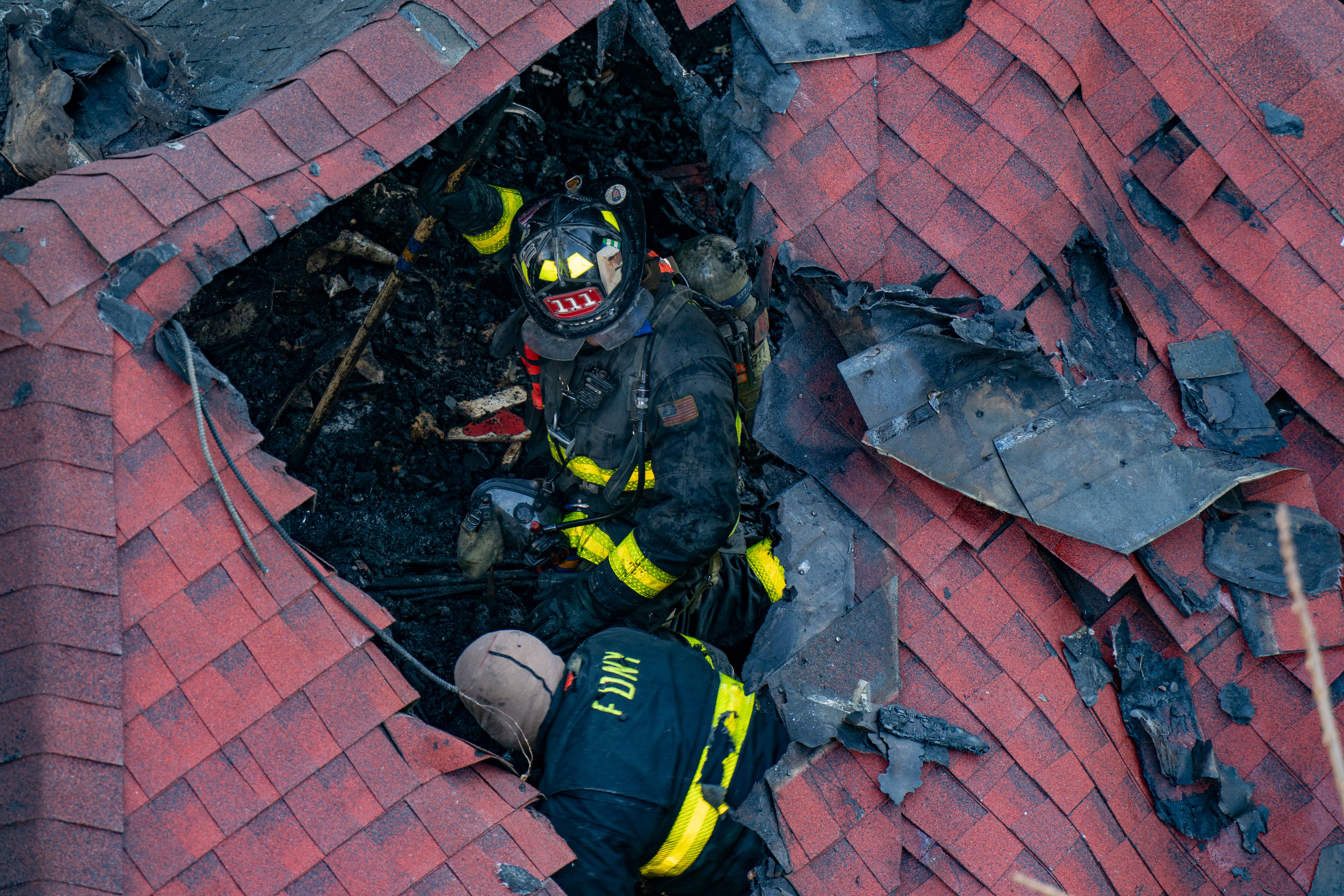 Firefighters on the scene of a two-alarm fire destroyed a...