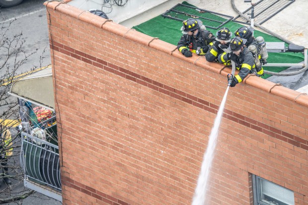 Three people were killed, including a child of unknown age, with several others suffering serious injuries, after a four-alarm fire broke out inside a two story residence at 44-49 College Point Boulevard in Queens on Monday March 16, 2026. 1309. (Theodore Parisienne / New York Daily News)