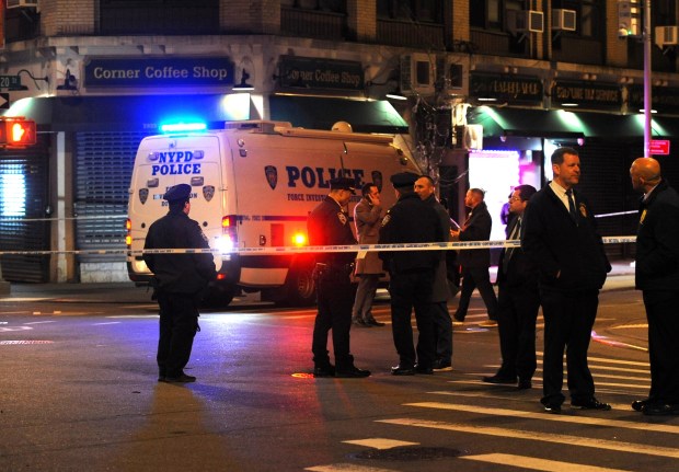 Police secure the scene on Mott Ave. in Far Rockaway, Queens after NYPD Officer Jonathan Diller was fatally shot while making a car stop.