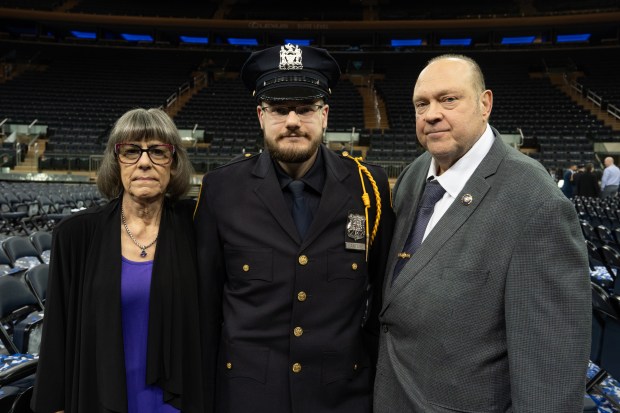 NYPD Officer Anthony Cantore, middle, poses for a photo with his father, NYPD Lt. Thomas Cantore, right, and his mother, Penelope Cantore, after his graduation ceremony in Madison Square Garden Monday, March 9, 2026 in Manhattan, New York. (Barry Williams/ New York Daily News)