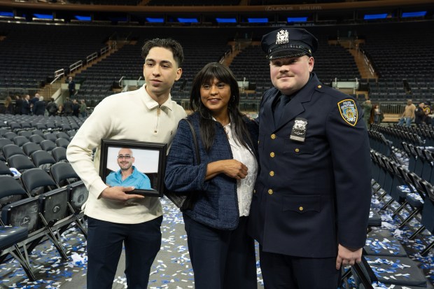 Inez Rosario and her son, Noah Rosario, left, pose with NYPD Officer Justin Acevedo, 23, after his graduation ceremony in Madison Square Garden Monday, March 9, 2026 in Manhattan, New York. (Barry Williams/ New York Daily News)
