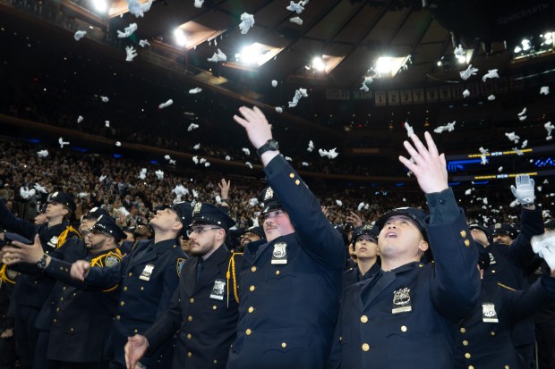Newly minted NYPD officers throw their dress gloves in the air during their graduation ceremony in Madison Square Garden on Monday, March 9, 2026, in Manhattan, New York. (Barry Williams/ New York Daily News)