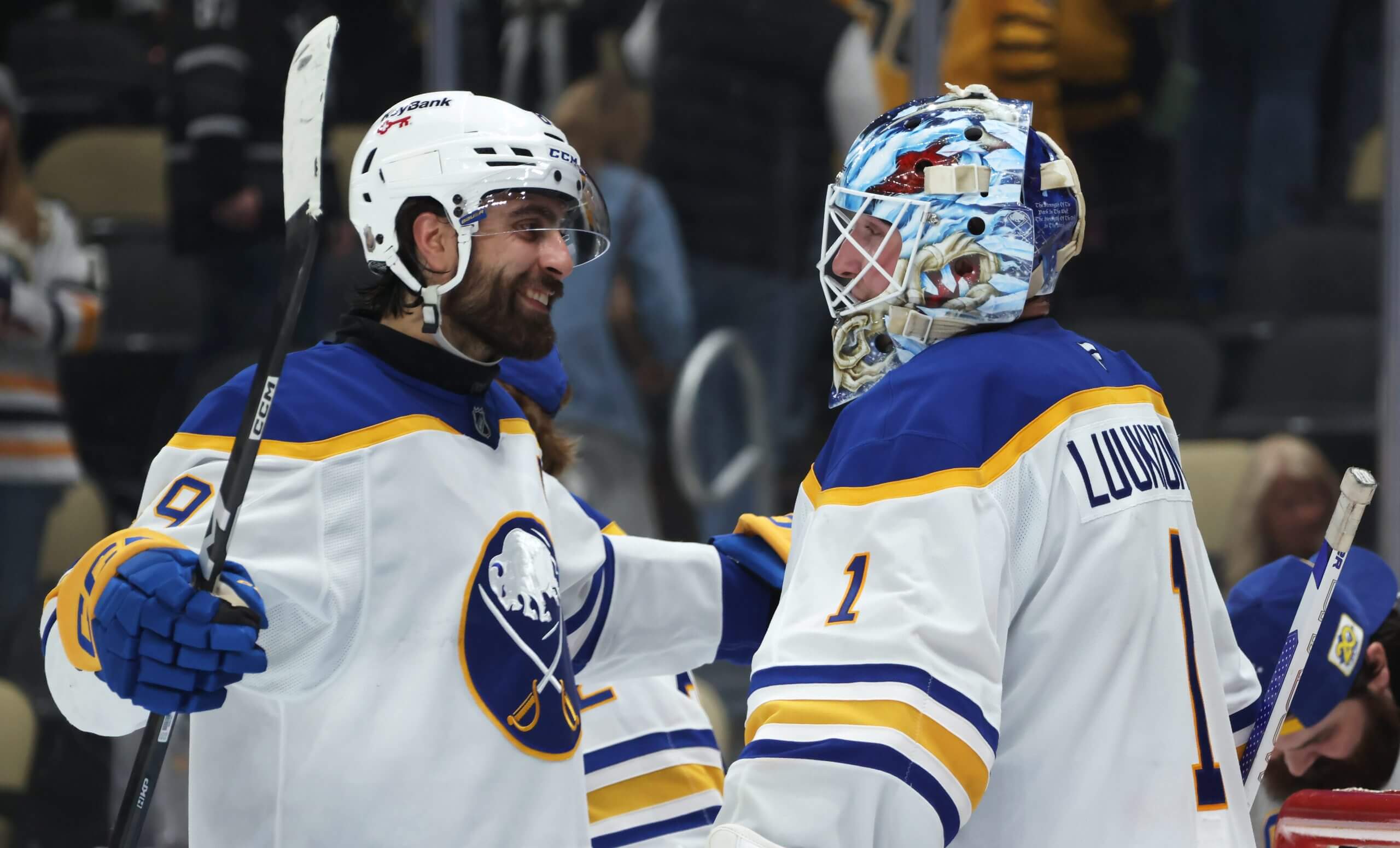 Alex Tuch smiles while hugging Sabres goalie Ukko-Pekka Luukkonen after a win.
