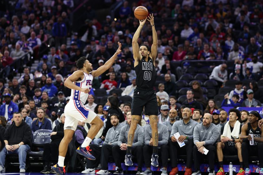 Mar 14, 2026; Philadelphia, Pennsylvania, USA; Brooklyn Nets forward Josh Minott (00) shoots past Philadelphia 76ers guard Quentin Grimes (5) during the first quarter at Xfinity Mobile Arena.