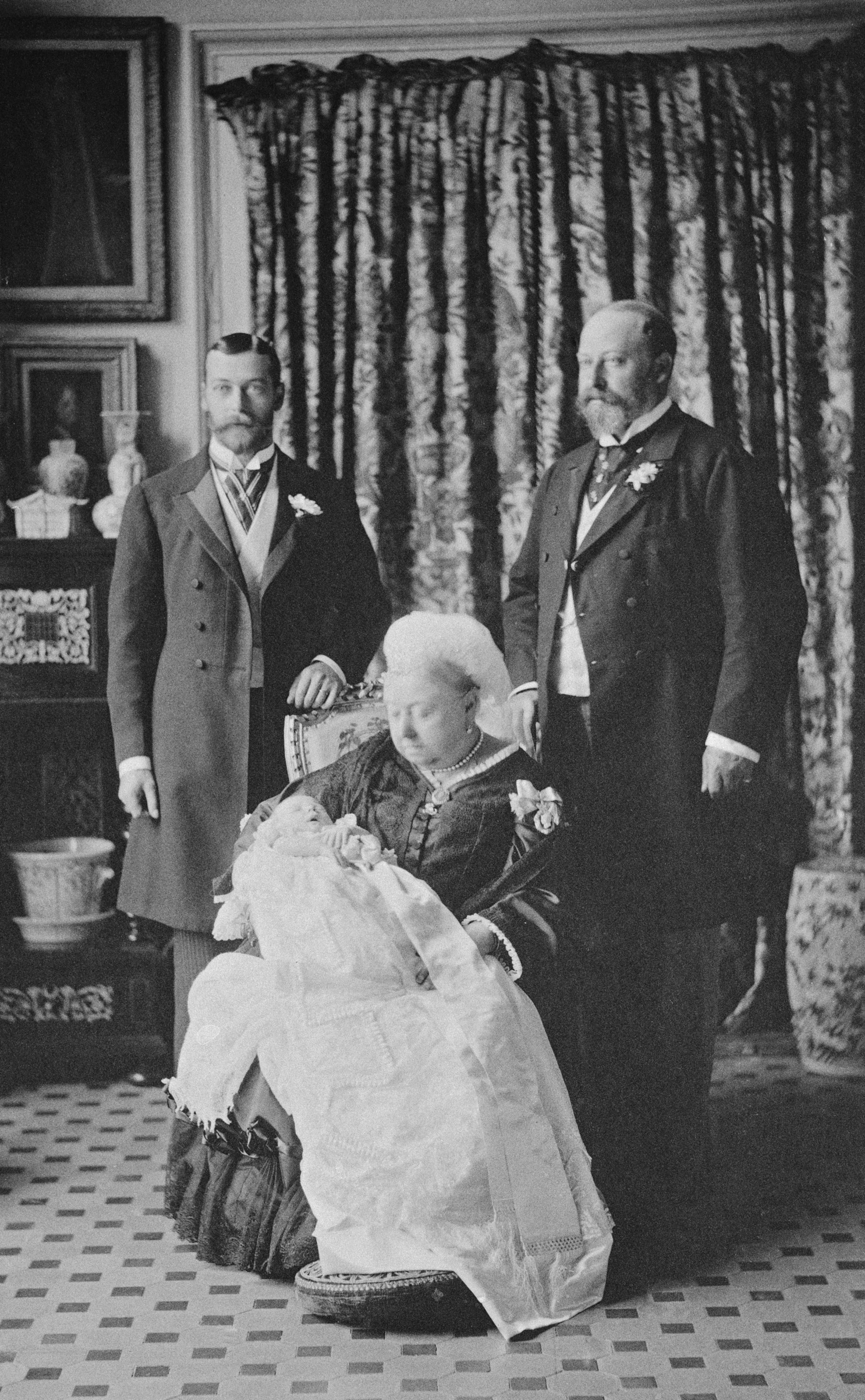 Queen Victoria holding the future King Edward at his christening
