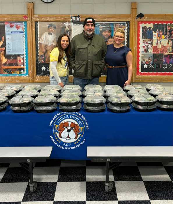 Forgash distributes meals at P.S. 7Q. Photo via Queens Together. 
