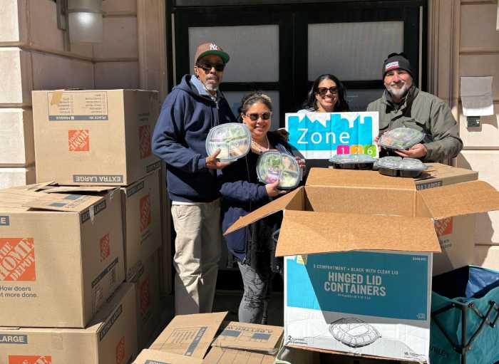 Forgash distributes food at Zone 126 in Astoria. Photo via Queens Together. 