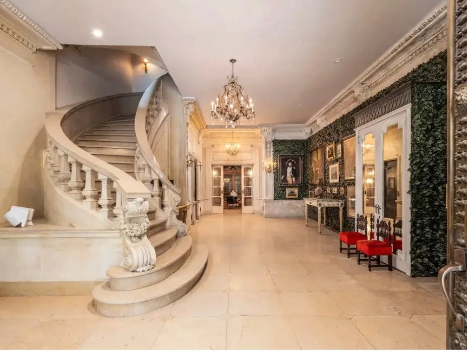 The first floor boasts white marble floors and a sweeping marble staircase.