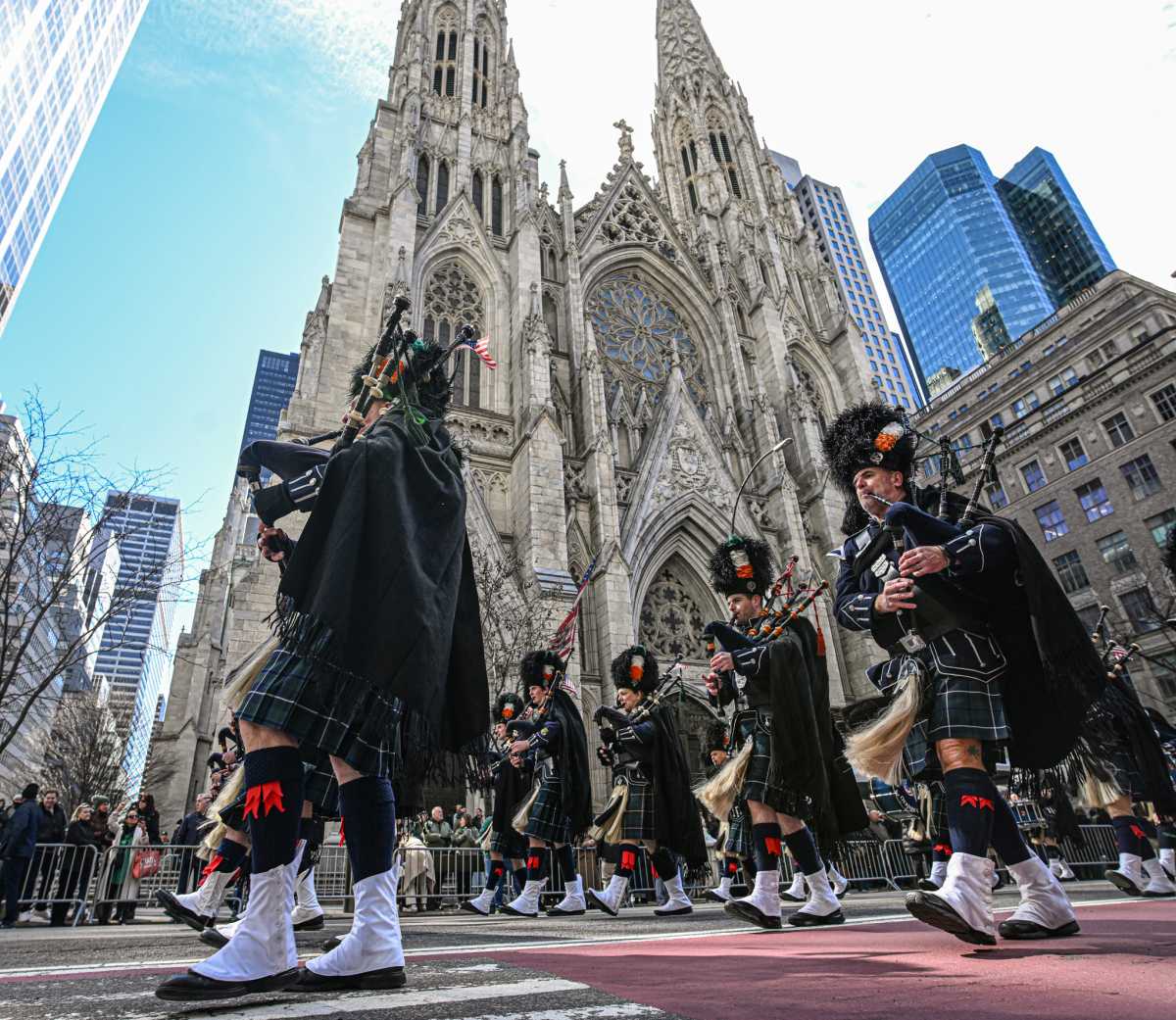 Bagpipers march past cathedral during St. Patrick's Day Parade in New York City