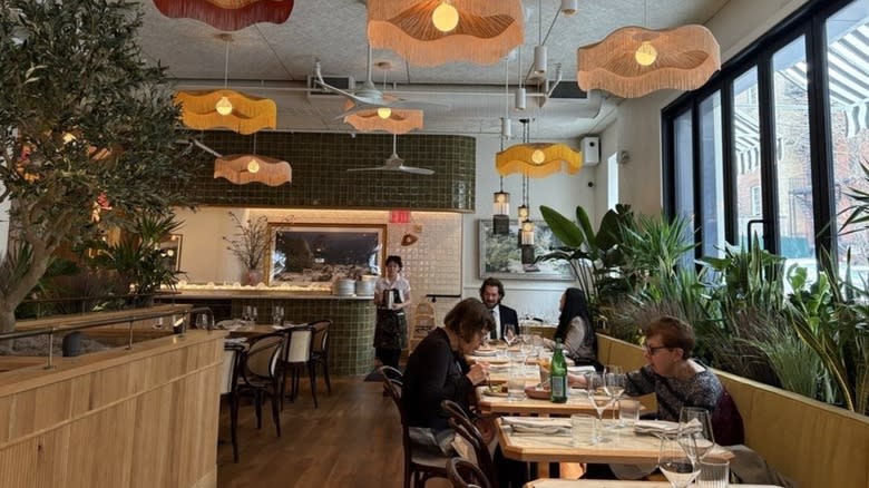 Sunny interior with plants in Leonetta restaurant, NYC