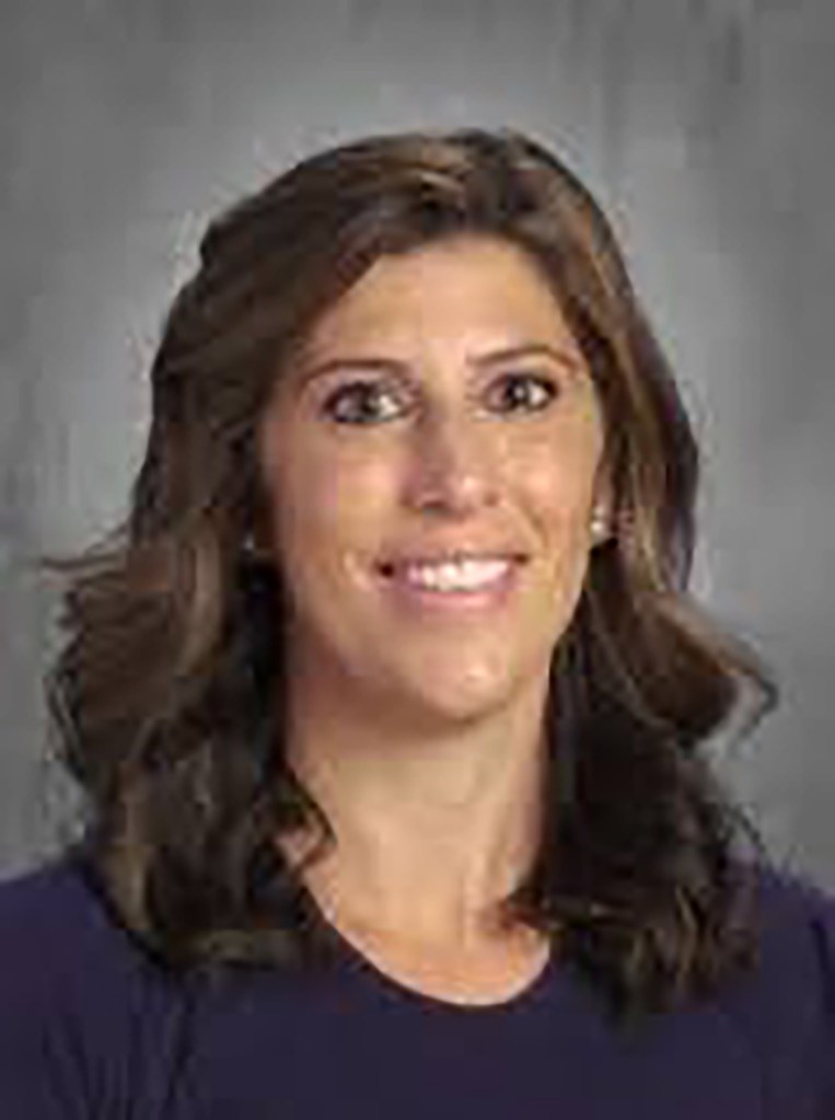 Alisha Crins, 39, smiling in a headshot against a gray background.