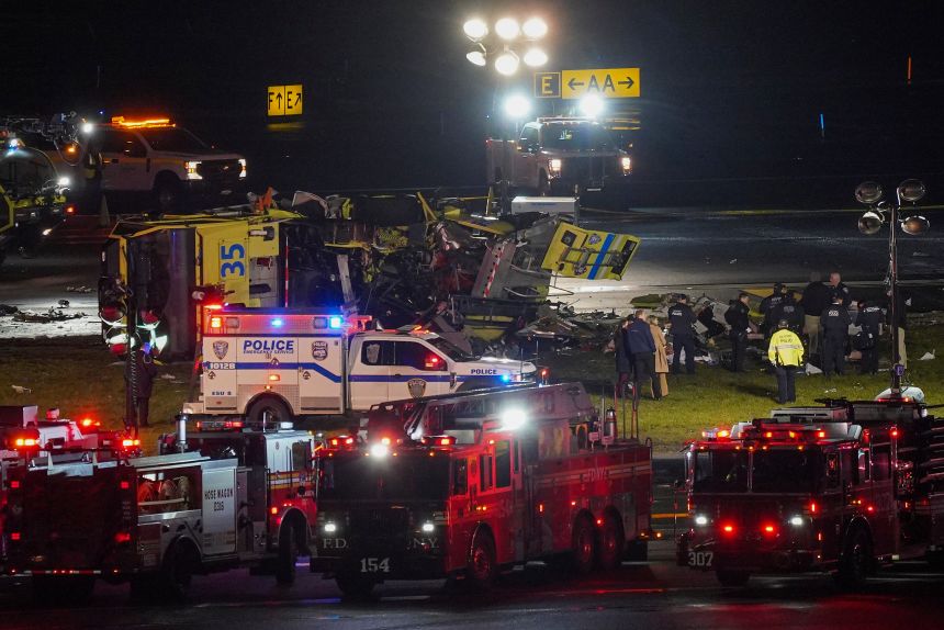 A Port Authority aircraft rescue and firefighting vehicle lays on its side off of runway 4 after colliding with an Air Canada jet after it landed at LaGuardia Airport, New York, on March 23, 2026.