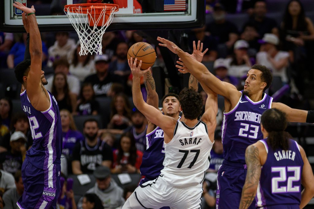 Ben Saraf (77) of the Brooklyn Nets attempts a shot over Dylan Cardwell, Nique Clifford, Patrick Baldwin Jr. (23), and Devin Carter (22) of the Sacramento Kings.