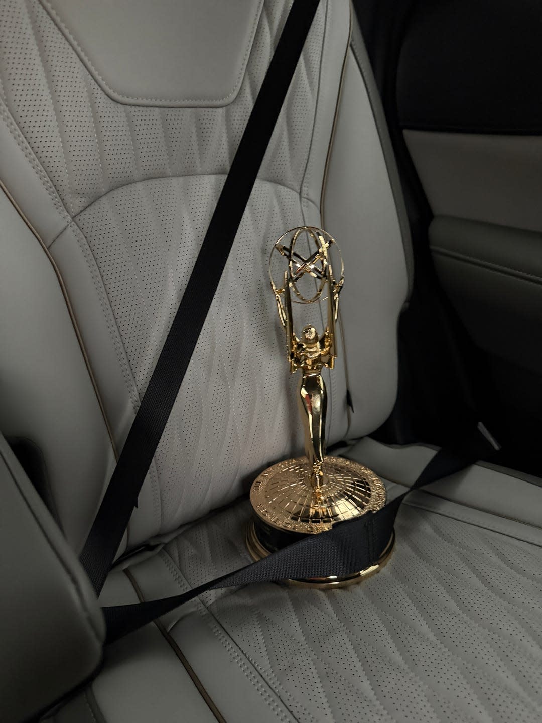 an award secured with a seat belt in a car