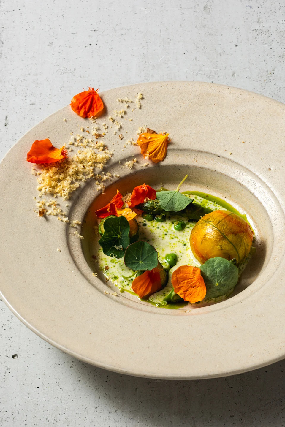 A bowl with food and flowers and dust.