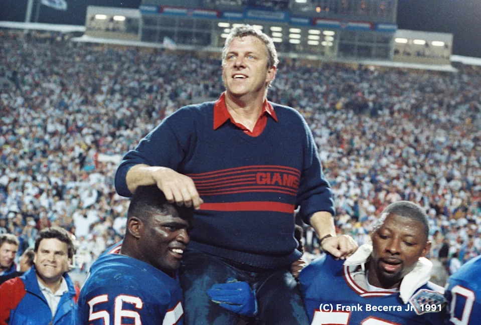 New York Giants Lawrence Taylor and Carl Banks carry head coach Bill Parcells off the field after the Giants defeated the Buffalo Bills 20-19 in Super Bowl XXV.