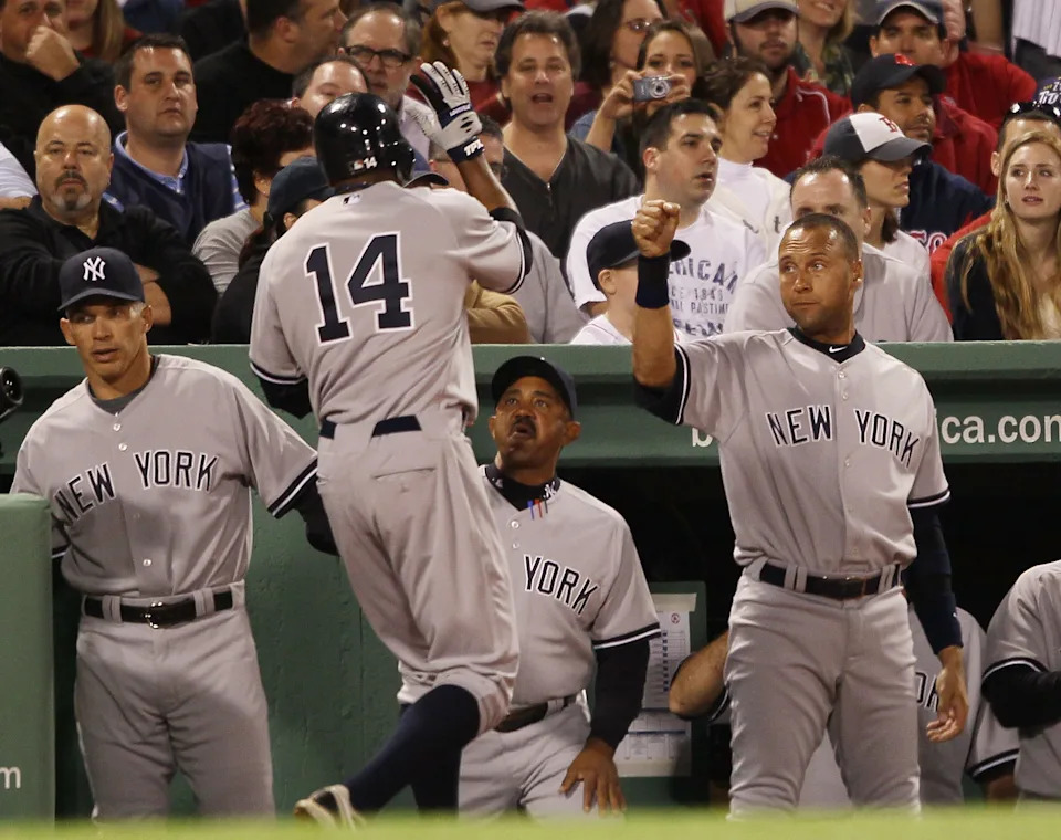 Curtis Granderson of the New York Yankees is congratulated by teammate Derek Jeter,