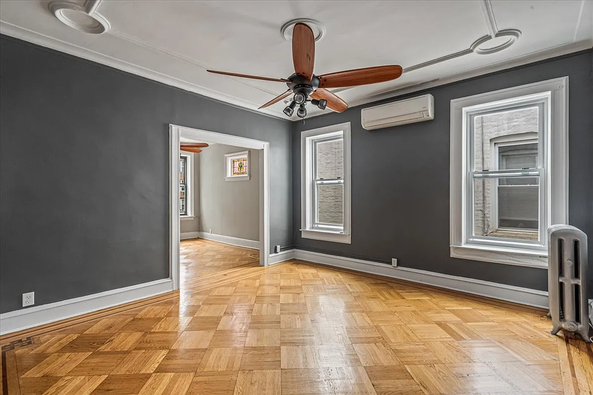 a dining room with wood floor, gray walls