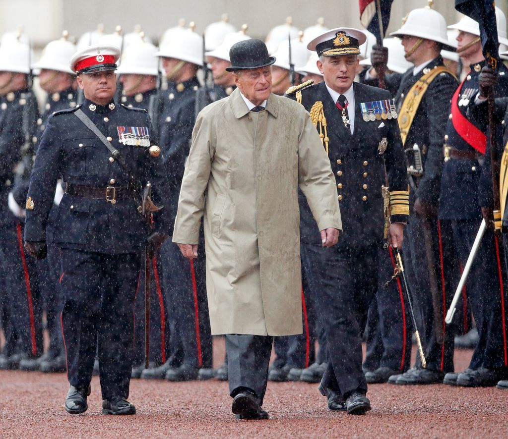 Prince Philip reviewing troops Buckingham Palace rain trench coat