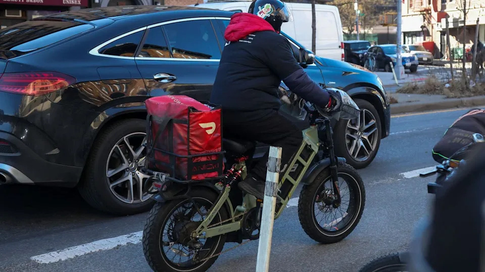 <div>A delivery worker with a DoorDash bag in the Brooklyn borough of New York, US, on Thursday, Jan. 15, 2026. The New York Department of Consumer and Worker Protection sent notices to major food-delivery platforms including Uber Eats, DoorDash, Grubhub and Instacart, warning them to comply with new worker protections taking effect later this month. Photographer: Michael Nagle/Bloomberg via Getty Images</div>