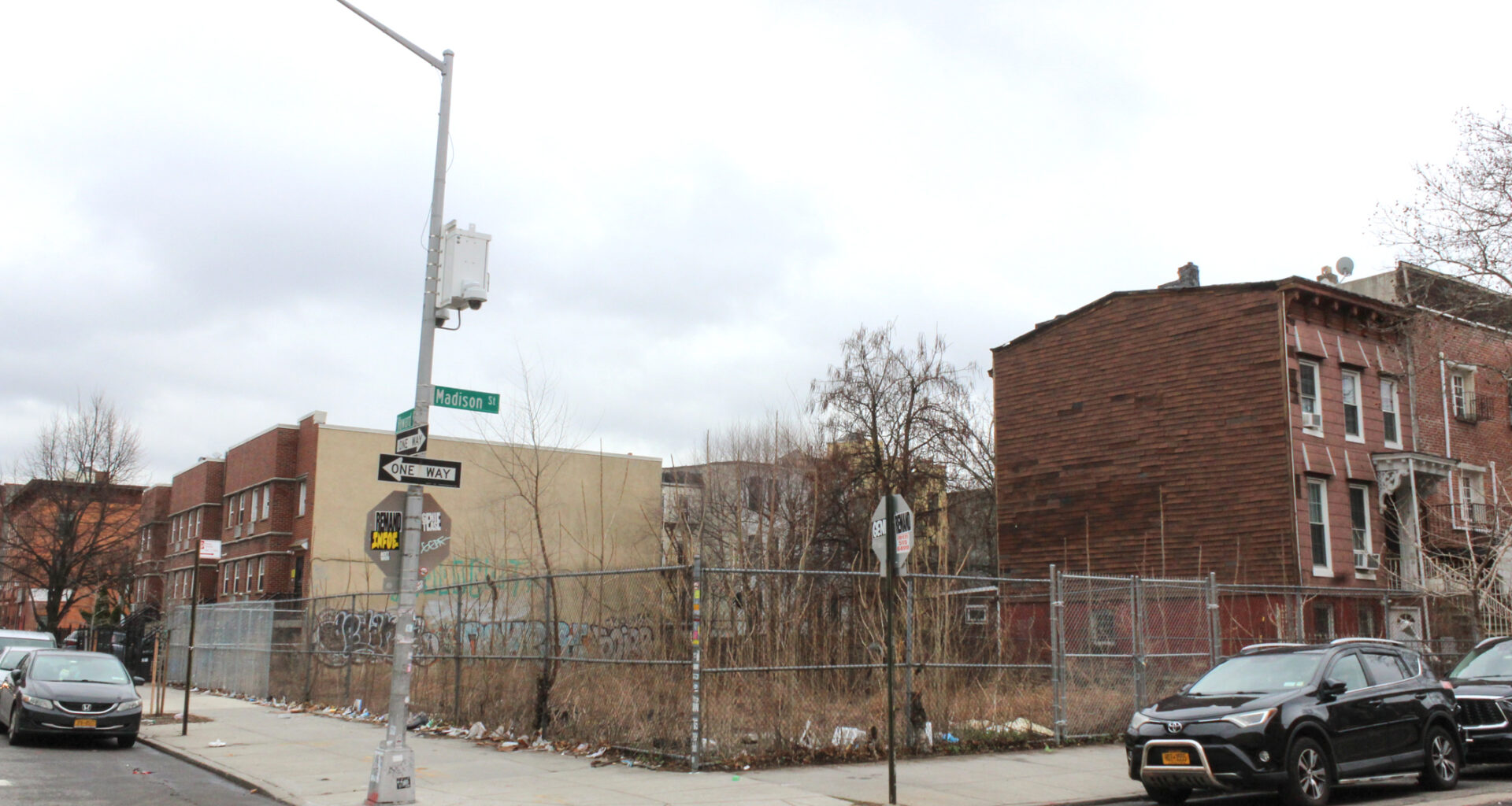 bed stuy empty lot with a chain link fence