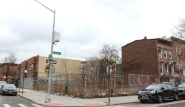 bed stuy empty lot with a chain link fence