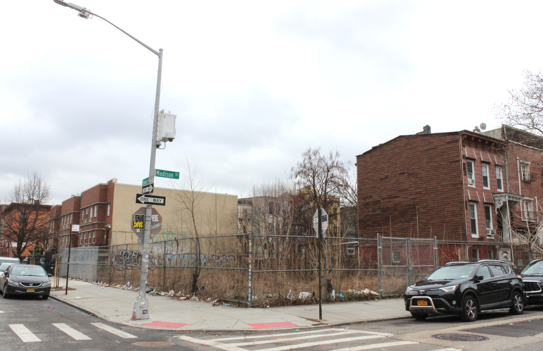bed stuy empty lot with a chain link fence