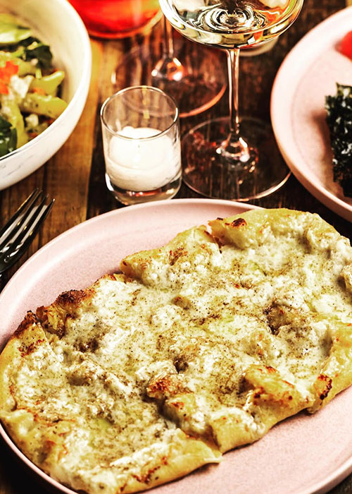 Somm Time's cacio e pepe personal pizza is one of the best wine bar snacks in NYC.