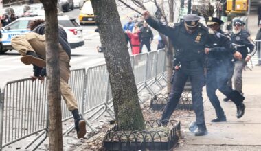 Activist flees after throwing a homemade explosive device towards police during a protest organized by far-right influencer Jake Lang against alleged