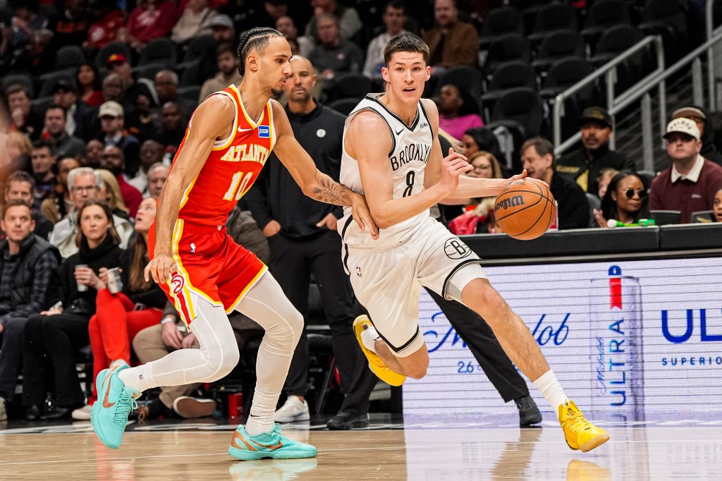 Brooklyn Nets guard Egor Demin dribbles the ball while guarded by Atlanta Hawks forward Zaccharie Risacher.