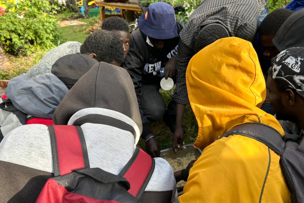 Migrants gathered for free meals at Bushwick City Farm in 2023.
