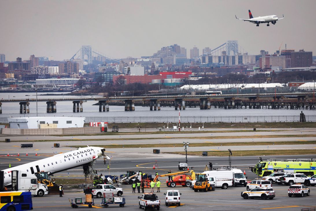 Officials investigate after an Air Canada Express plane collided with a fire truck on the tarmac at LaGuardia Airport in New York City.