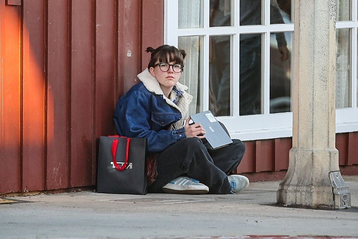 Fin Affleck was spotted in Brentwood playing on a computer near the Big Blue Bus stop, keeping it casual in a denim jacket, brown pants, and Adidas sneakers. 