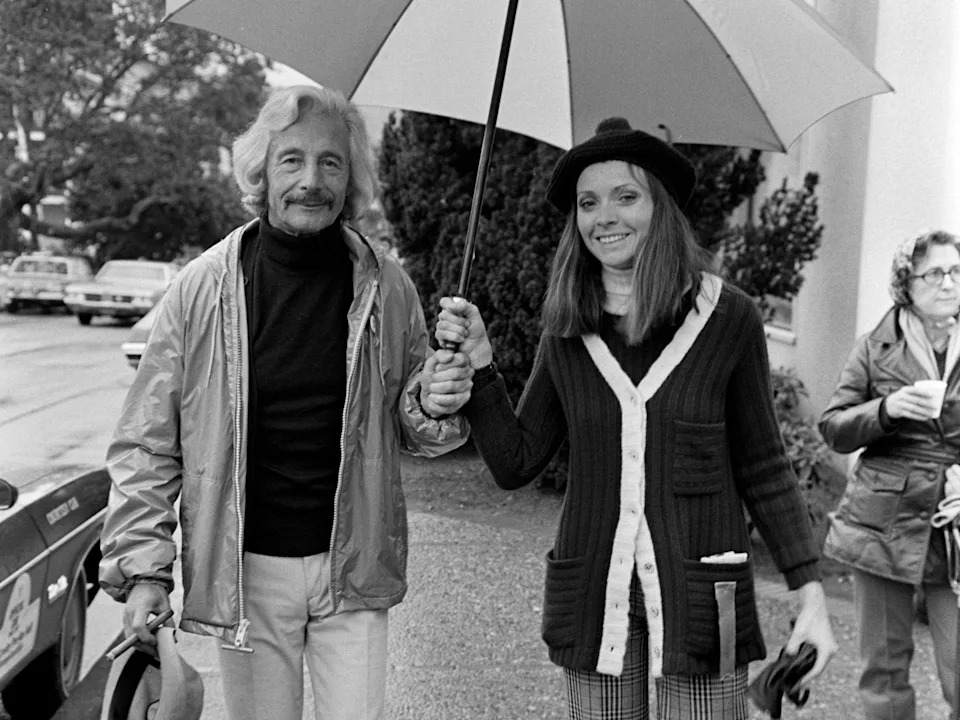 "Jackie O" designer Oleg Cassini walks with Marianne Nestor down a Pebble Beach, California, sidewalk in 1974, three years after their secret marriage.