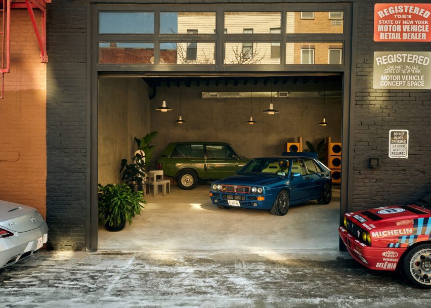 A car showroom visible through an open garage door