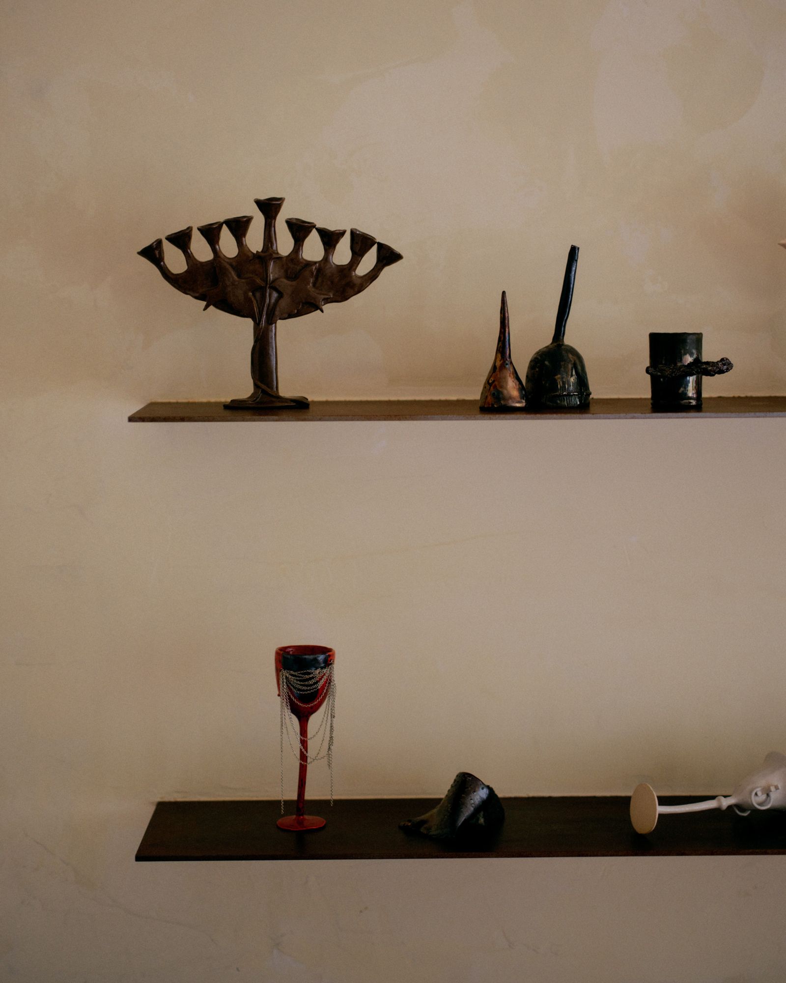 Image may contain Shelf Festival Hanukkah Menorah Glass and Furniture