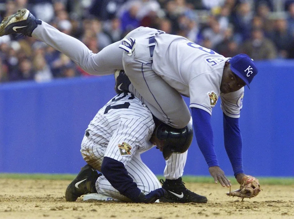 Yankees' Bernie Williams collides into Kansas City Royals' Carlos Febles as he is tagged out at second base.