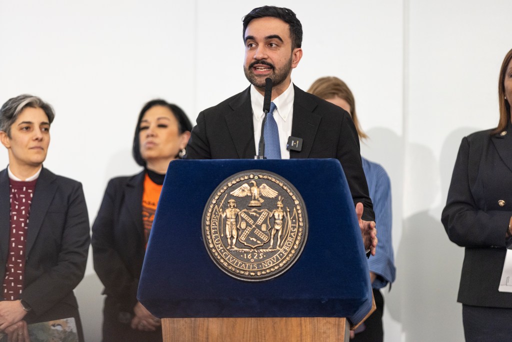 Zohran Mamdani speaking at a Rental Ripoff hearing at Fordham University.