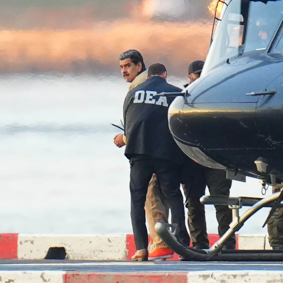 Xny/star Max/GC Images via Getty Images, FILE - PHOTO: In this Jan. 5, 2026, file photo, Nicolas Maduro is seen in handcuffs after landing at a Manhattan helipad, escorted by heavily armed Federal agents as they make their way into an armored car en route to a Federal courthouse in New York.