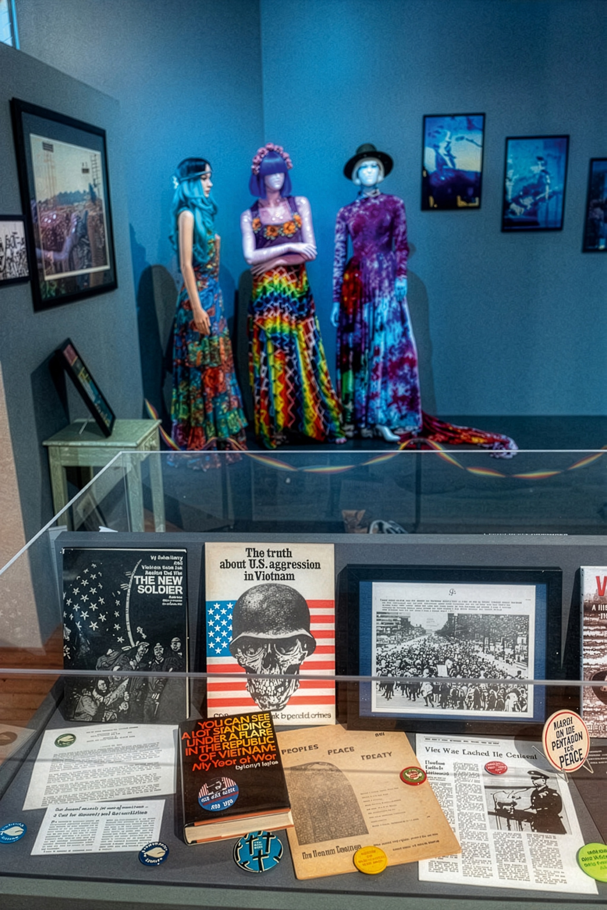 The interiors of a museum exhibition with mannequins wearing hippie dresses in the background.