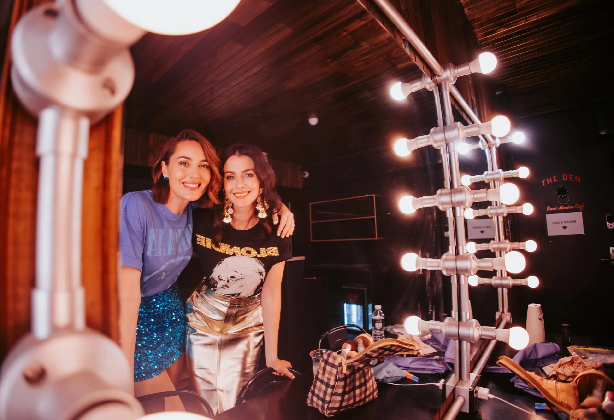 women smiling in light globe mirror 