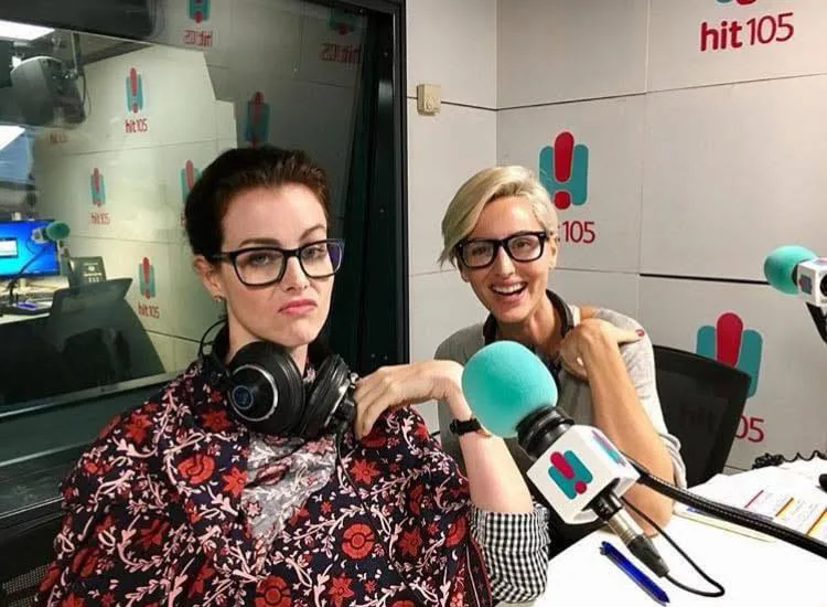 two women in front of microphones in radio studio
