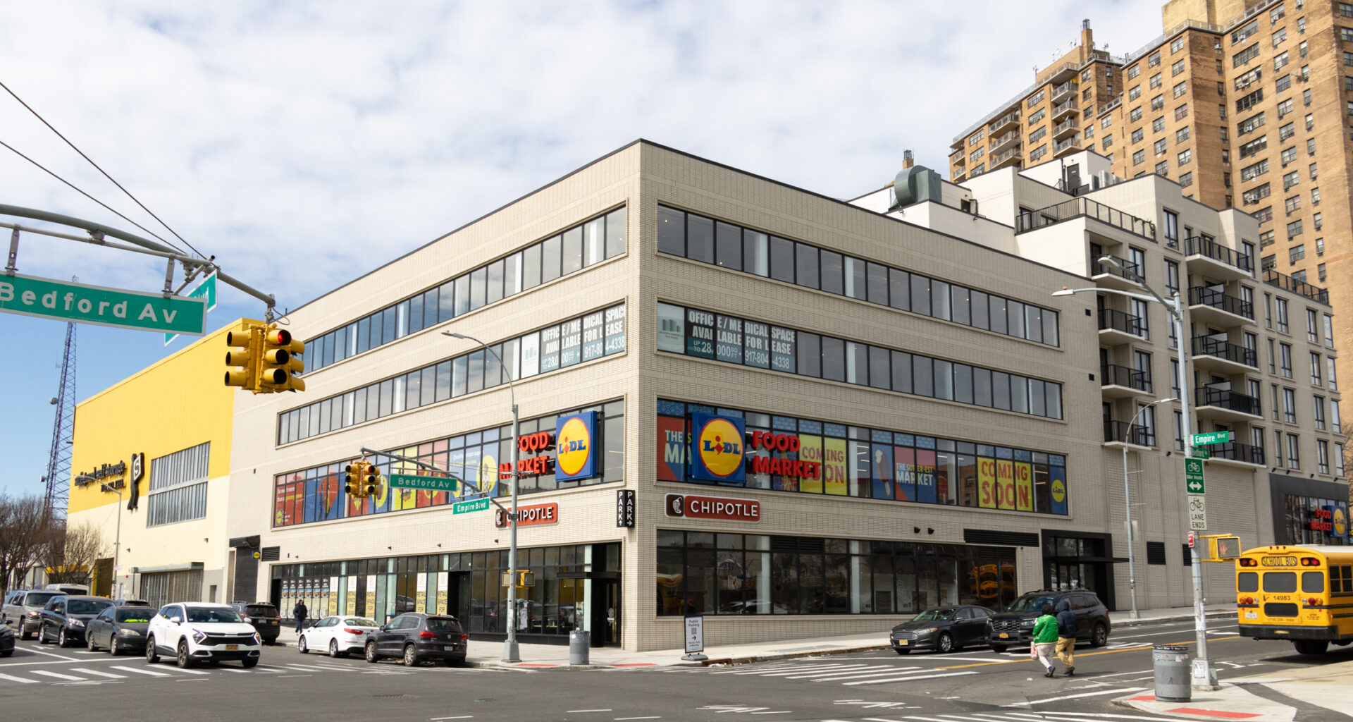 new building of light brick with a grocery store