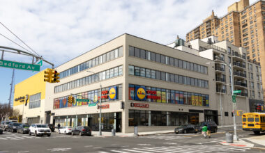 new building of light brick with a grocery store